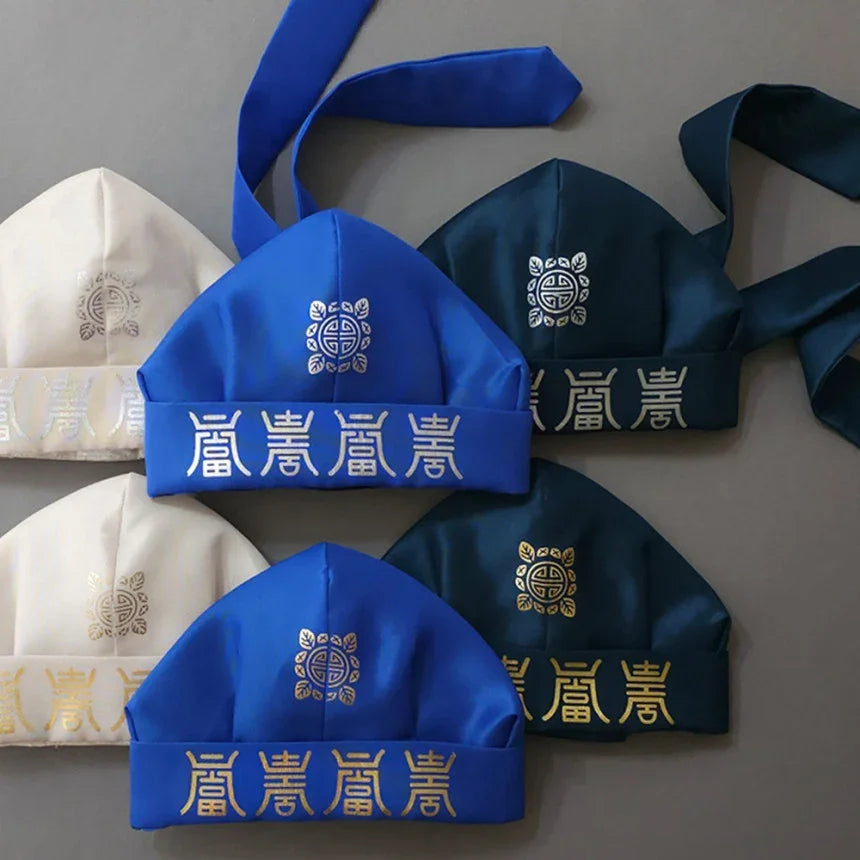 Six Yuhan Gunmo traditional Korean hats in blue, navy, and white by Native Korean.