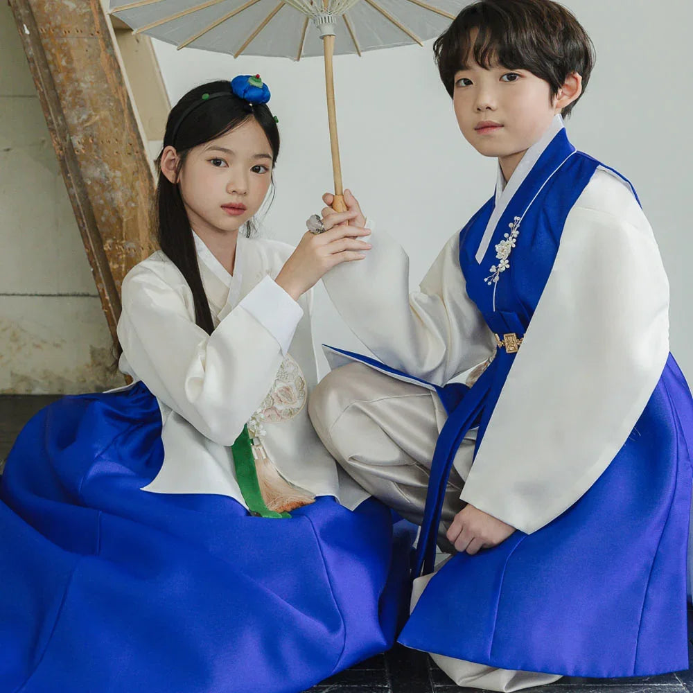 Children wearing Native Korean girl and boy hanbok, featuring a blue chima and blue jeogori.