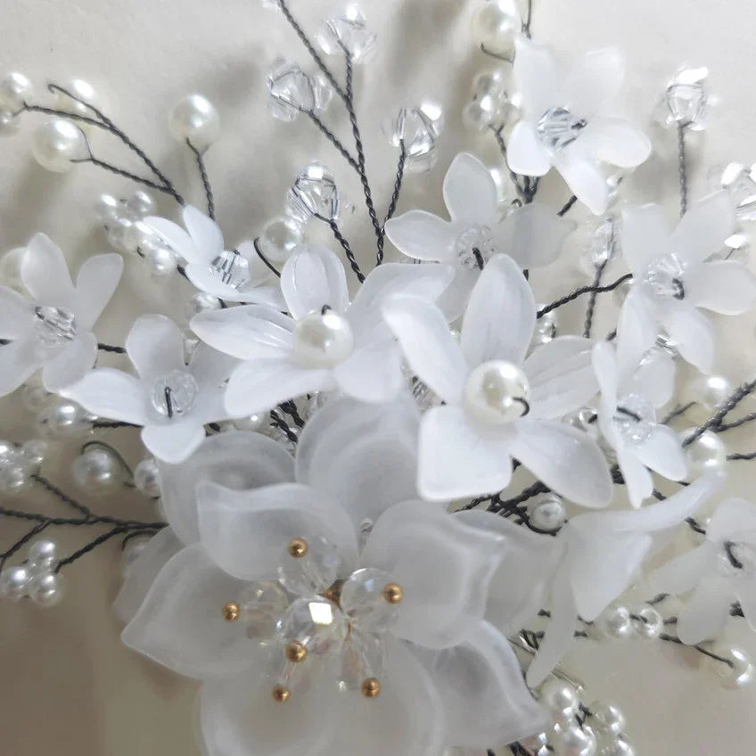 Close-up of a Native Korean Spring Blossom Hanbok hairpin with white floral accents and pearls.