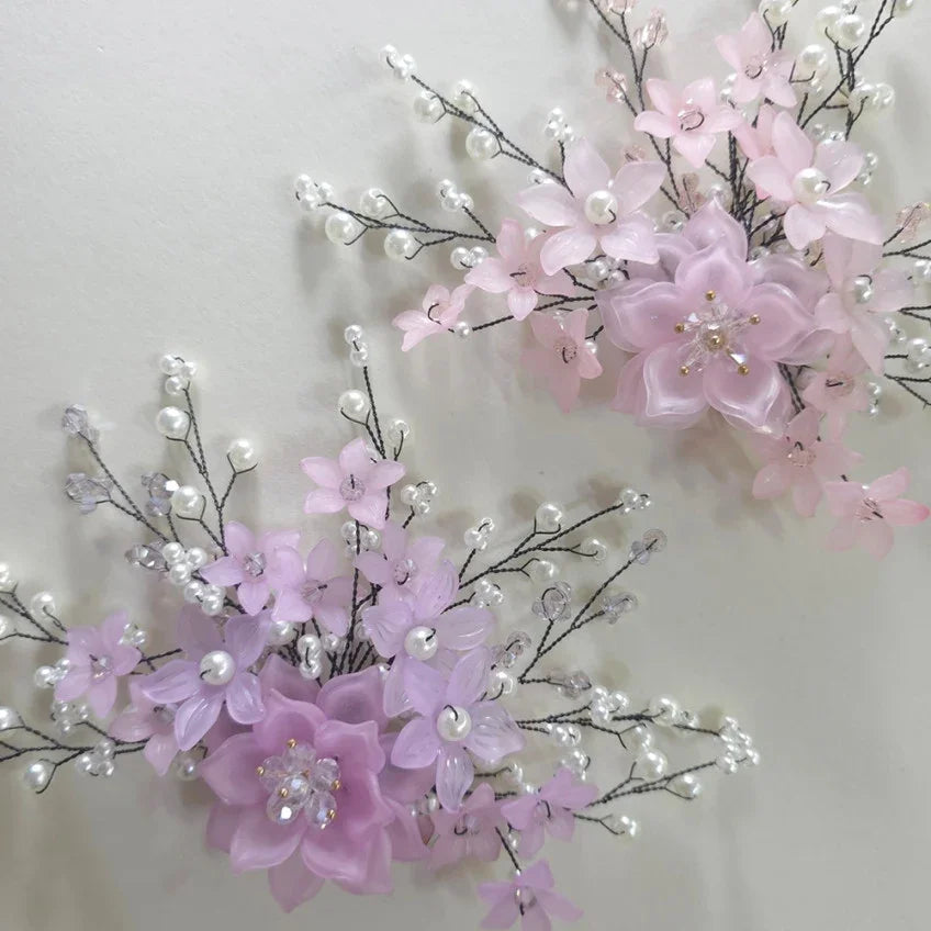 Two Native Korean Spring Blossom Hanbok hairpins in light pink and lilac floral designs.