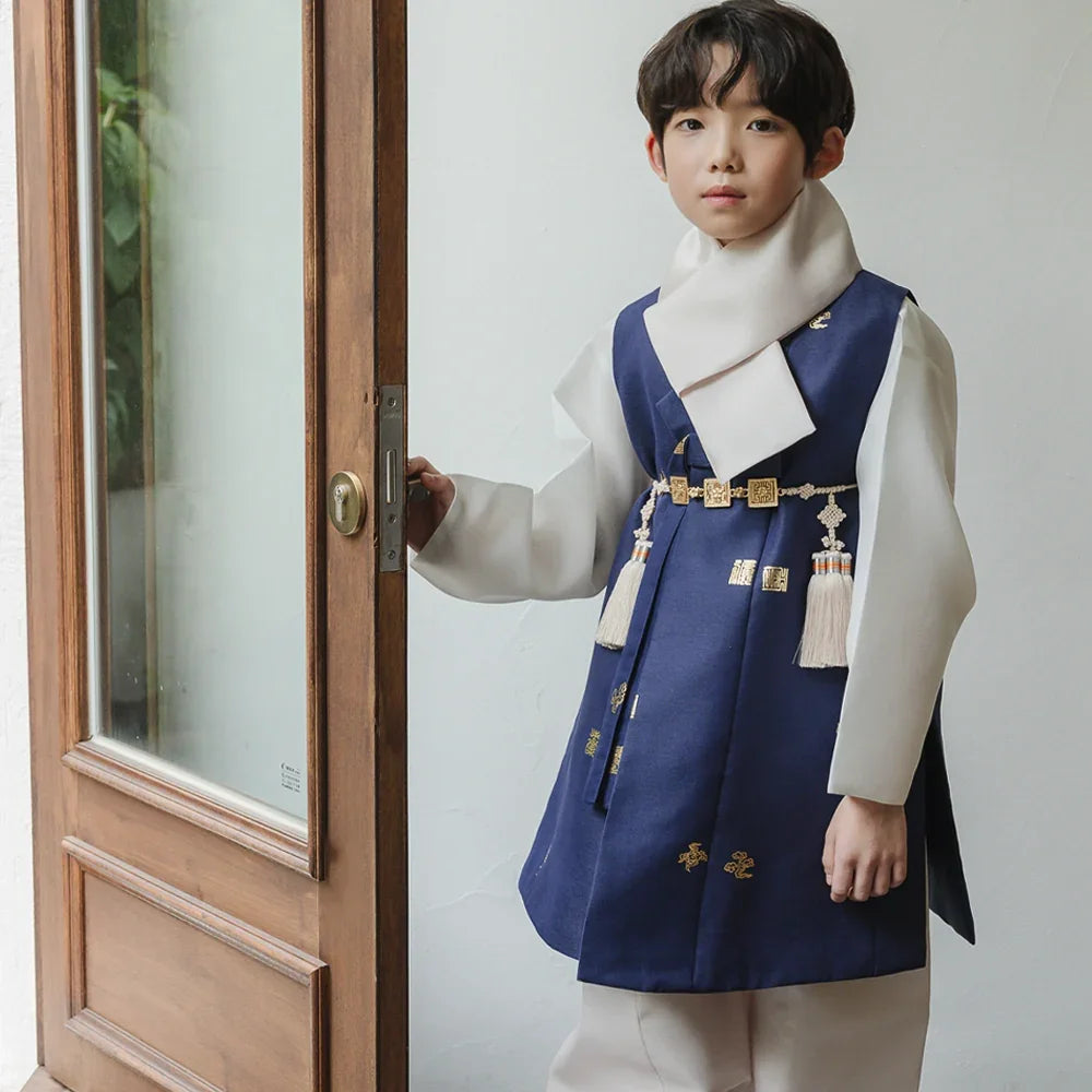Young boy wearing a navy blue and white Native Korean Boy Hanbok with a Norigae ornament.