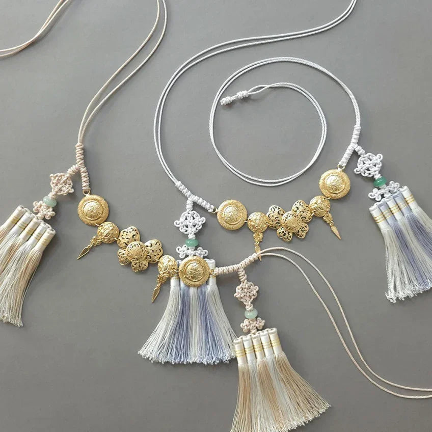 Native Korean gold medal tassel Norigae accessory with intricate metalwork and white tassels