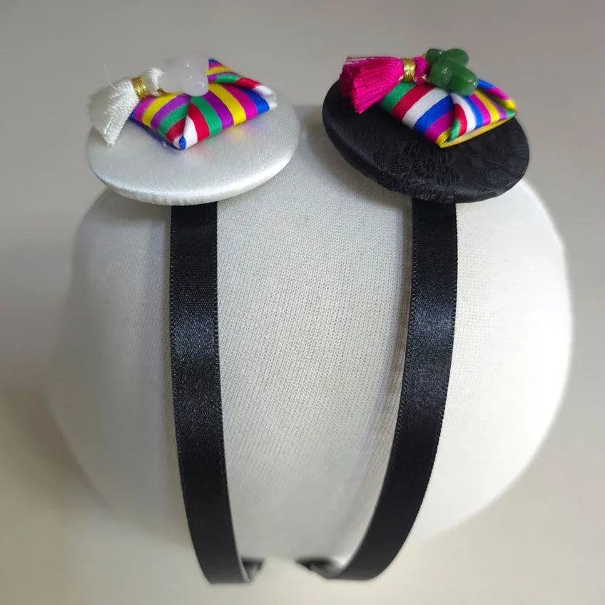 Two Native Korean Saekdong Ddakji headbands in black and white.