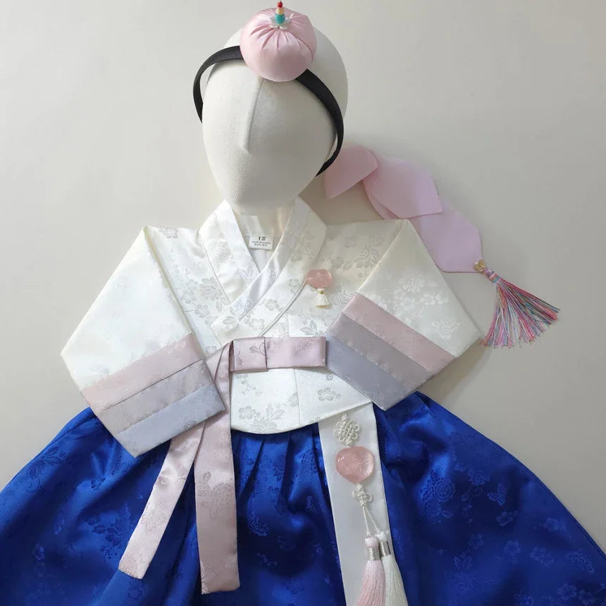Native Korean Girl Hanbok with white jeogori, blue chima, Jokduri, and Norigae.