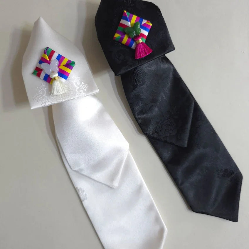 White and black Native Korean Saekdong Ddakji hair ties with colorful traditional accents.