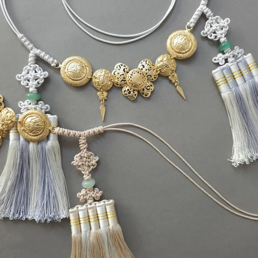 Detailed view of a Native Korean gold medal tassel belt with traditional Norigae elements.