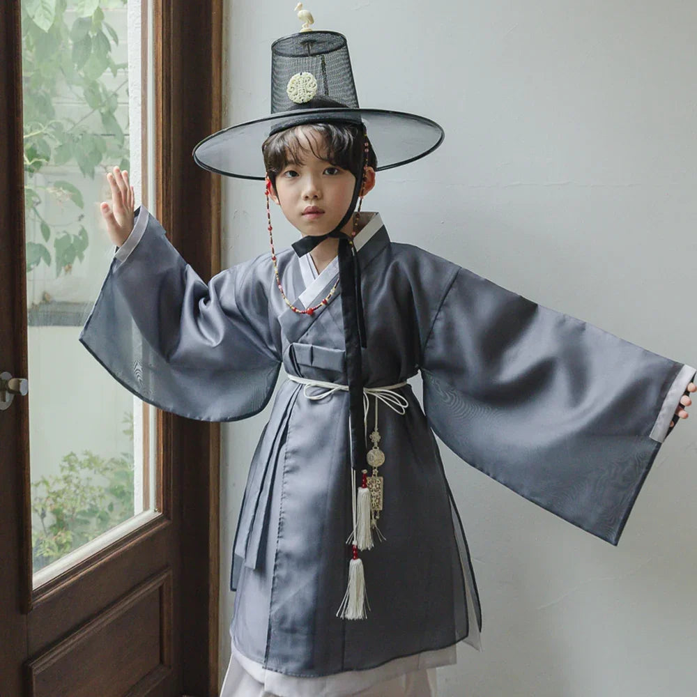 Child wearing a Native Korean Gunyun gray dopo boy hanbok and a traditional gat hat.