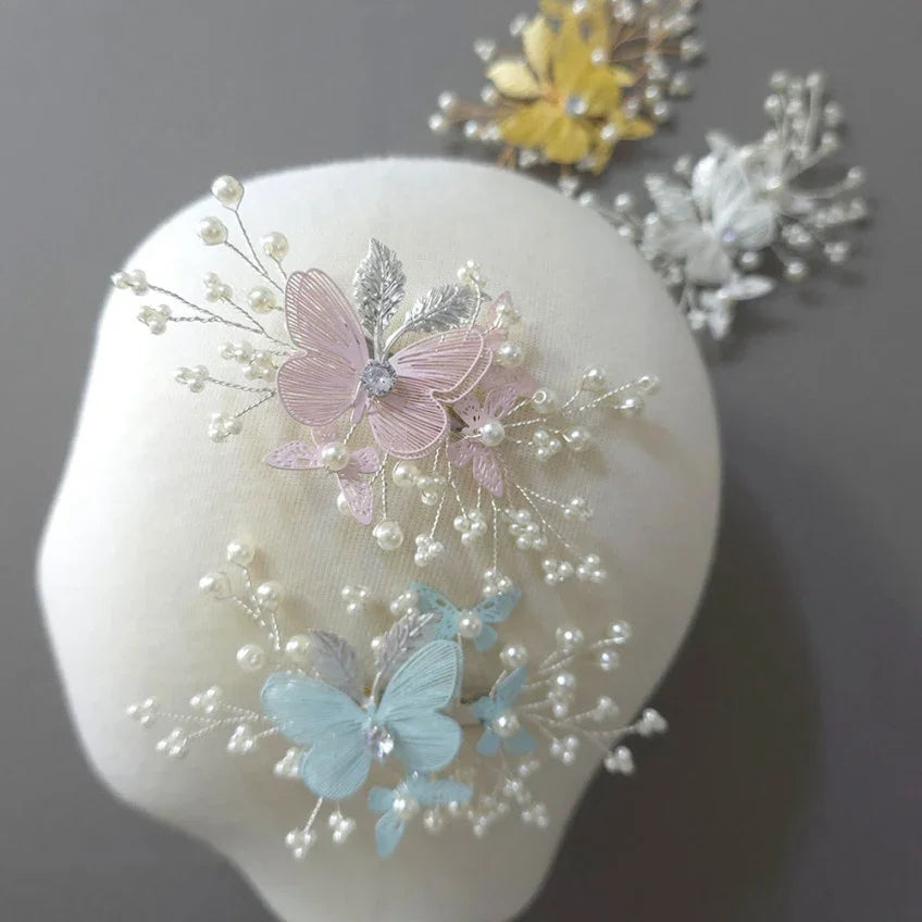 Native Korean Sana Butterfly Hairpins in pink, blue, and yellow on a white display head