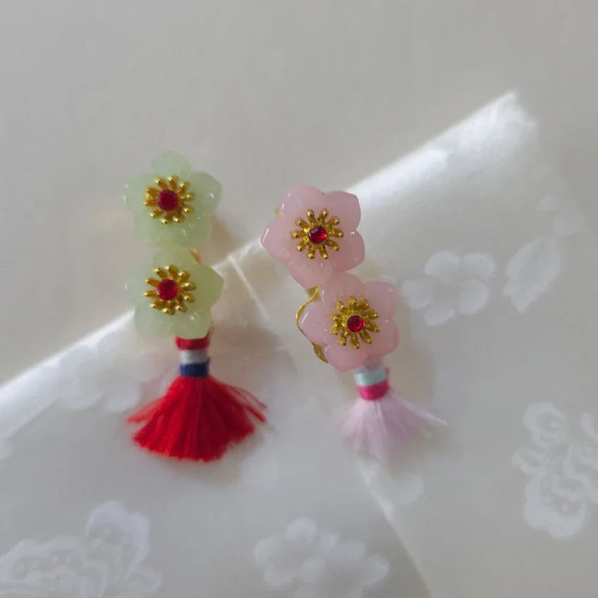 Pair of Native Korean flower-shaped Norigae brooches in light green and pink with tassels.