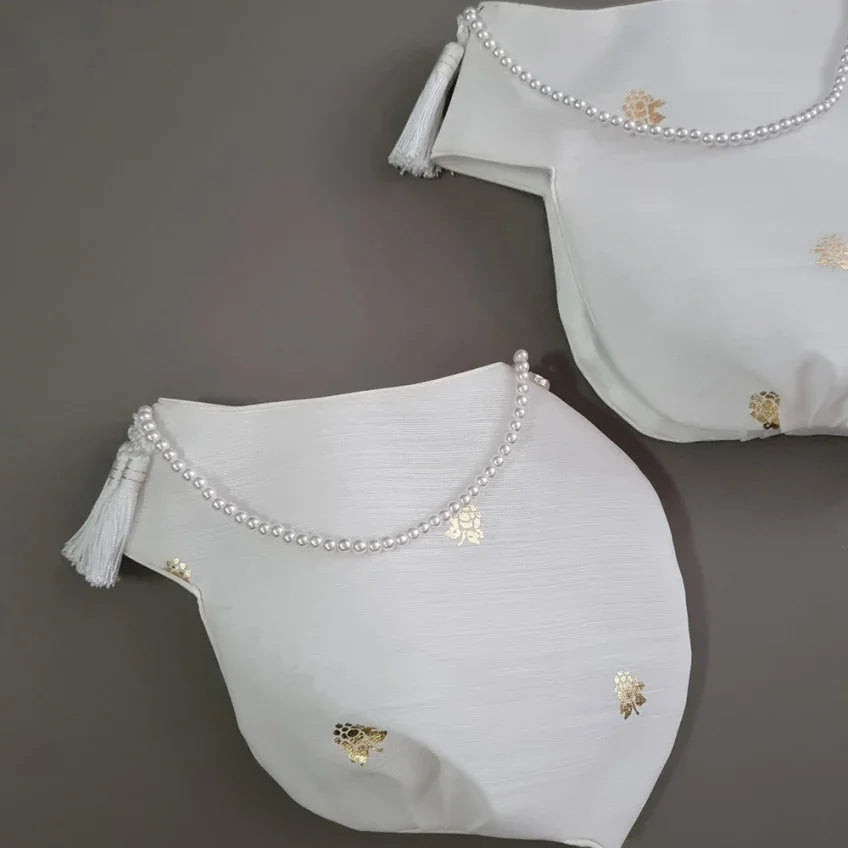 Two white Native Korean Yebon Jobawi with pearl trim and gold leaf patterns