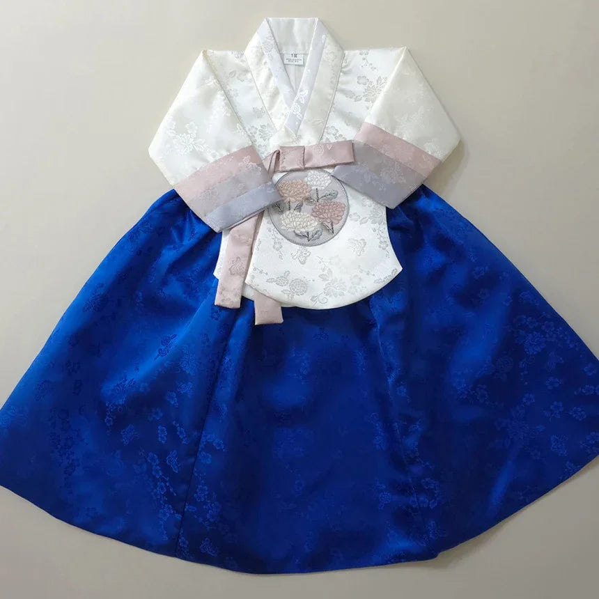 Girl Hanbok with a white floral jeogori and blue chima.