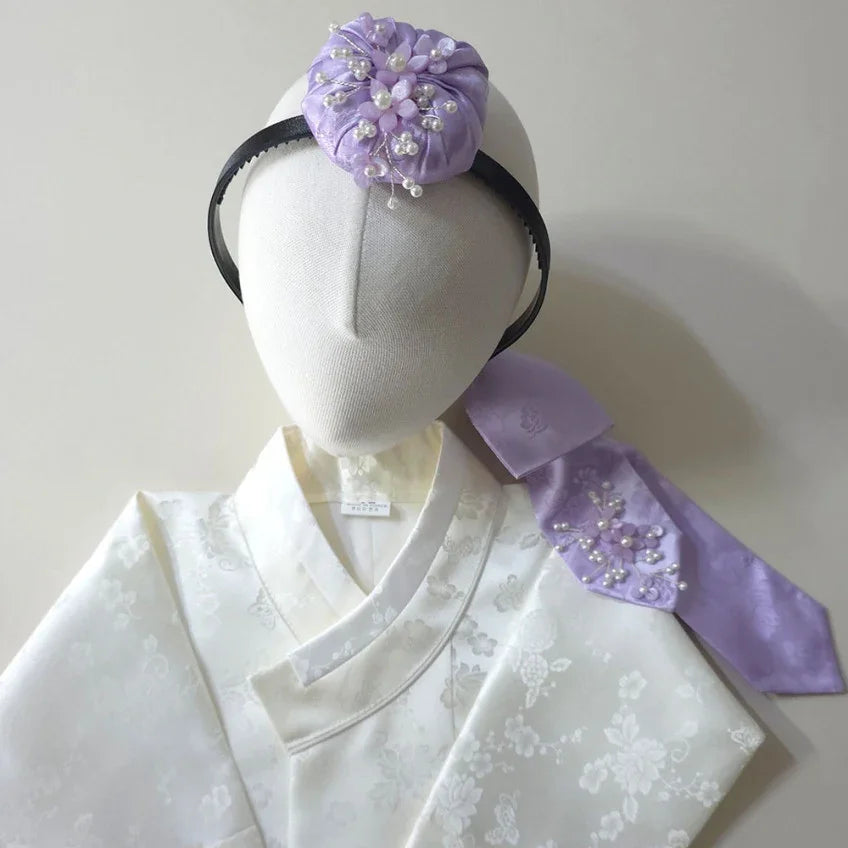 Lavender floral Jokduri headband and matching Daenggi ribbon on a white Native Korean hanbok.