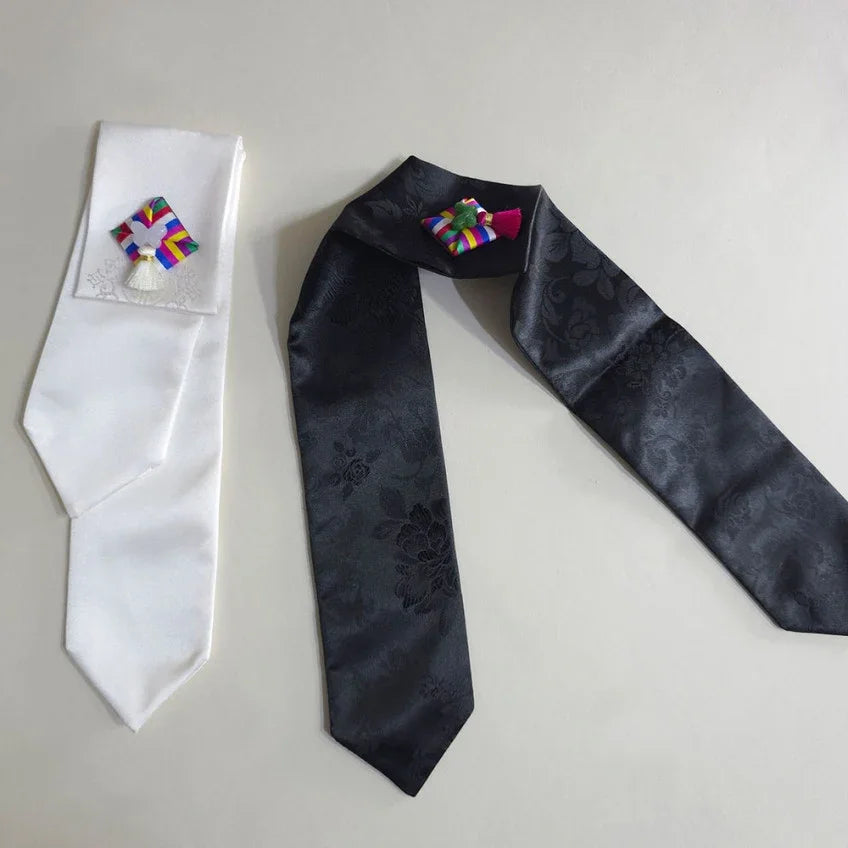White and black Native Korean Saekdong Ddakji hair ties with traditional colorful patterns.