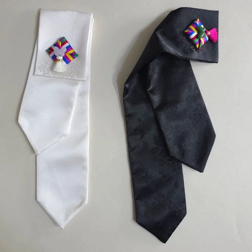 White and black Native Korean Saekdong Ddakji hair ties with colorful accents.