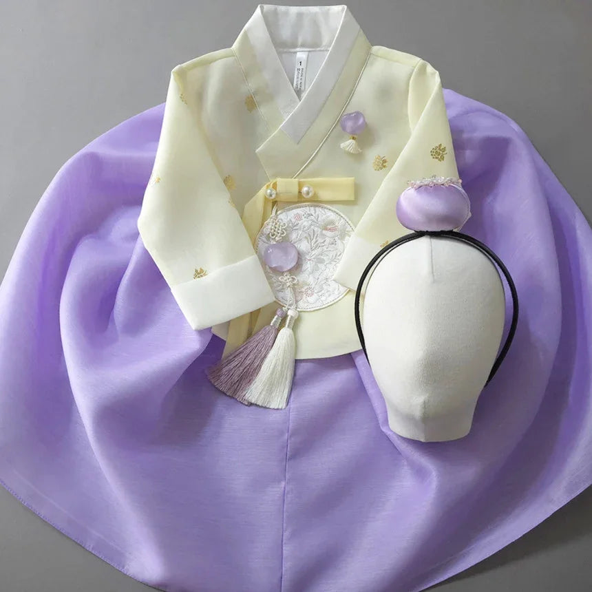 Native Korean Girl Hanbok featuring a pale yellow jeogori, purple chima, and jokduri.