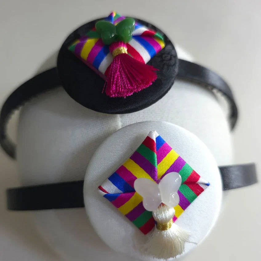 Native Korean Saekdong Ddakji Headband with colorful striped fabric and tassel accents
