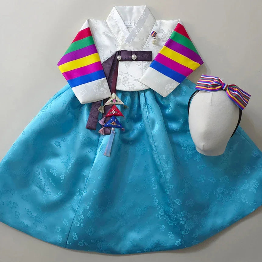 Native Korean Girl Hanbok with saekdong jeogori, sky blue skirt, norigae, and matching headband.