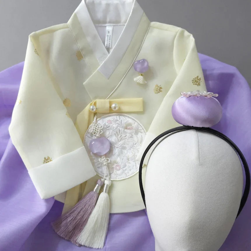 Pale yellow Native Korean Girl Hanbok with a purple Jokduri and Norigae accessory