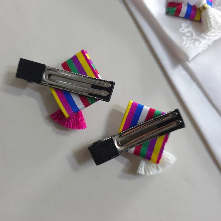 Two Native Korean Saekdong Ddakji hairpins with colorful stripes and tassels.