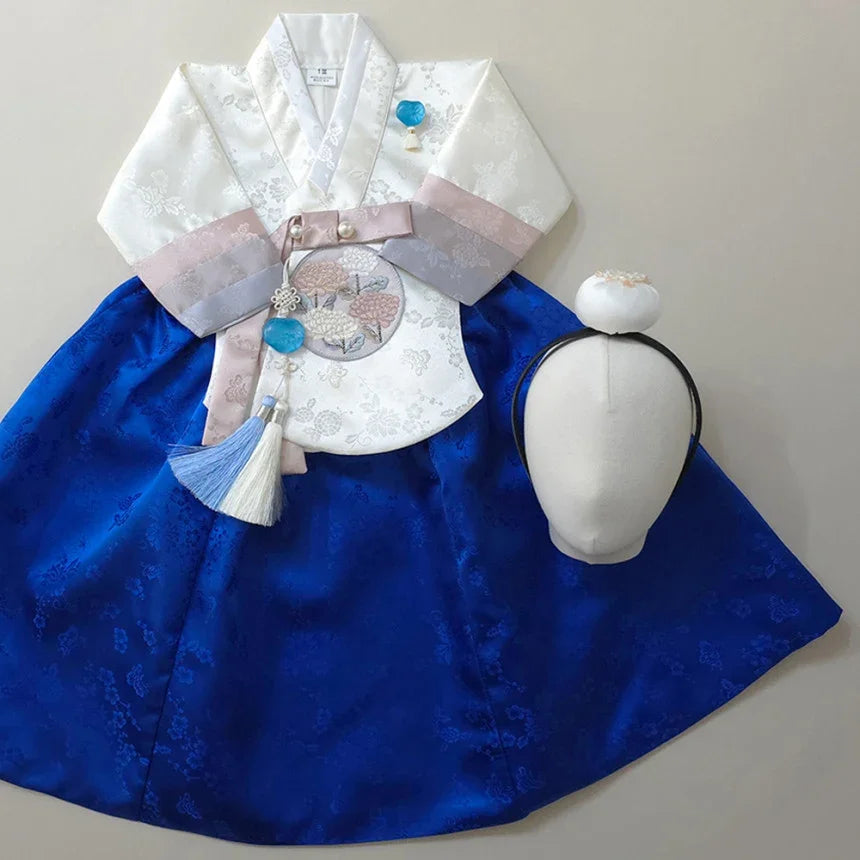 Yunjae Sky Blue Girl Hanbok with white jeogori, blue chima, and decorative norigae.