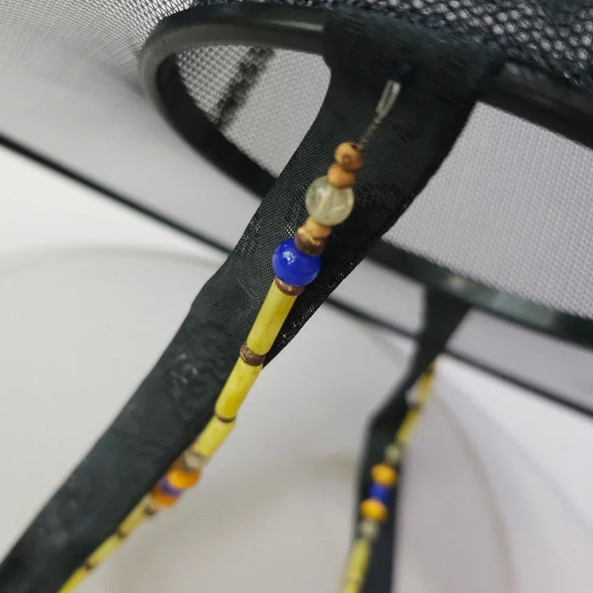 Close-up of a yellow and blue natural stone Gat string by Native Korean.