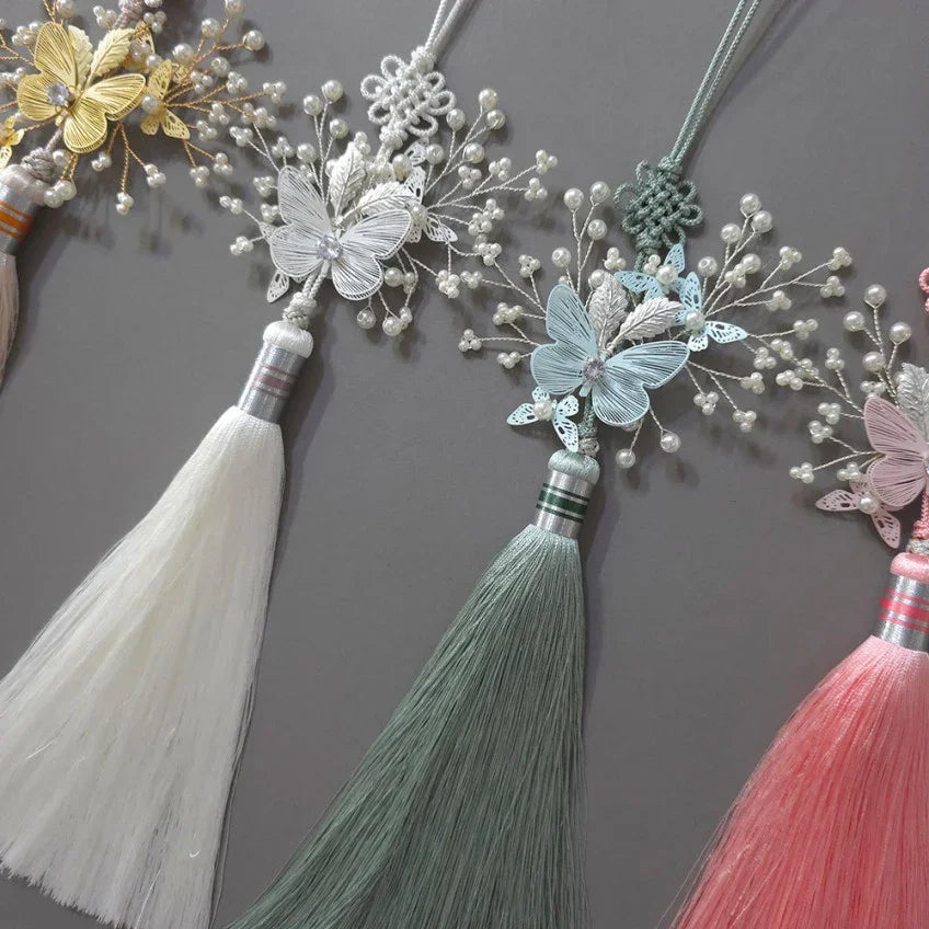 Detailed view of yellow, white, blue, and pink Sana Butterfly Tassel Norigae by Native Korean.