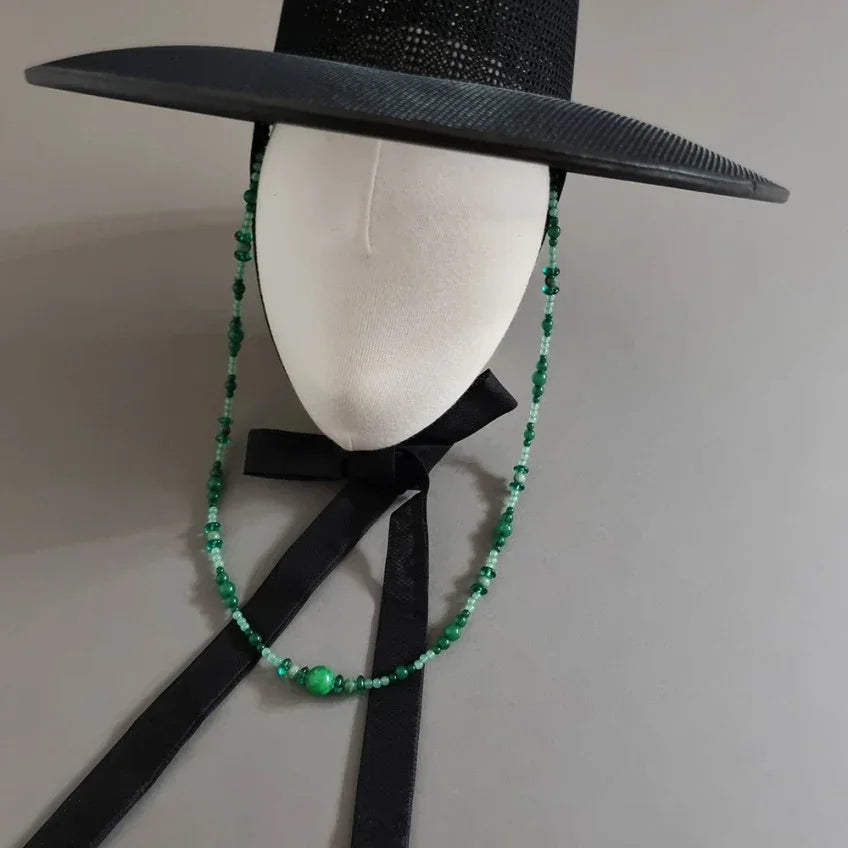 Green natural stone Gat string on a black traditional Korean Gat hat by Native Korean