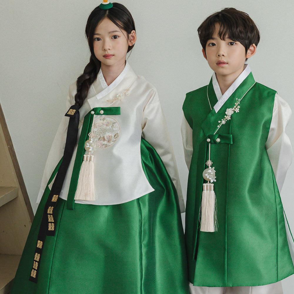 A girl and boy wearing green and white Native Korean hanbok with Norigae accessories.