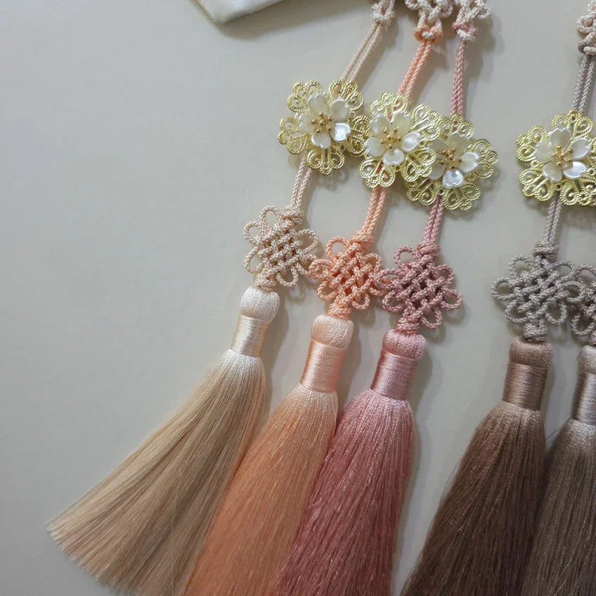 Three Bloom Trio Tassel Norigae by Native Korean in gold, peach, and pink tones.