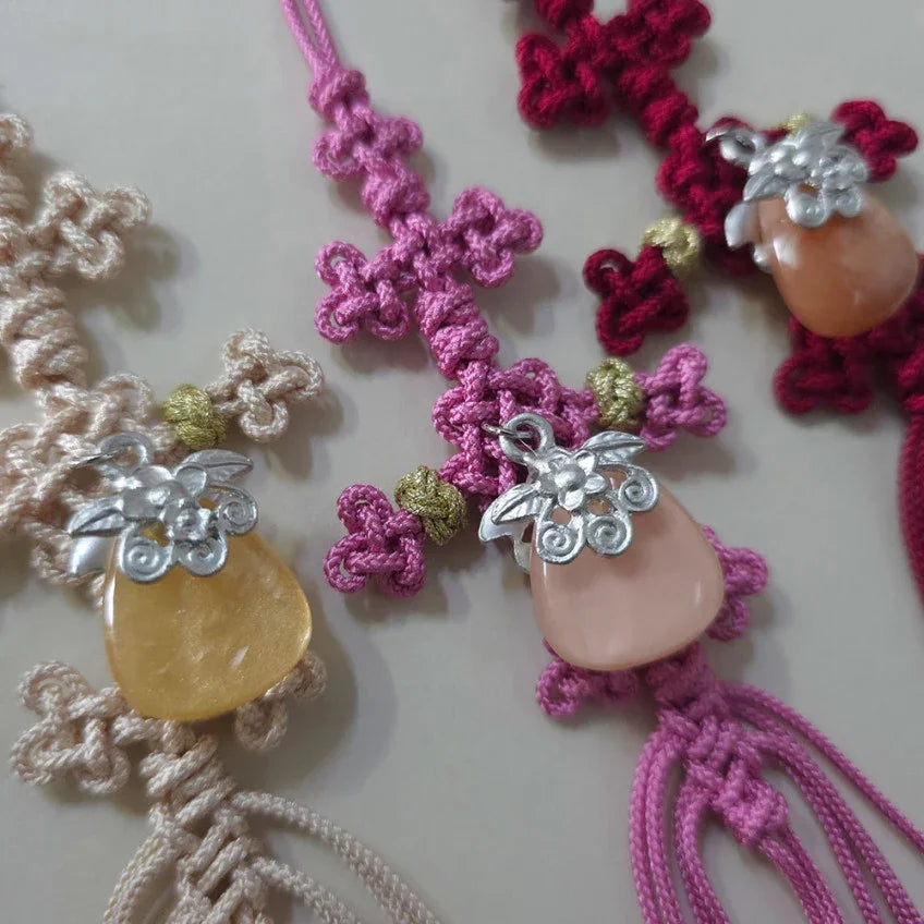 Three colorful Native Korean knotted Norigae with decorative charms and tassels.