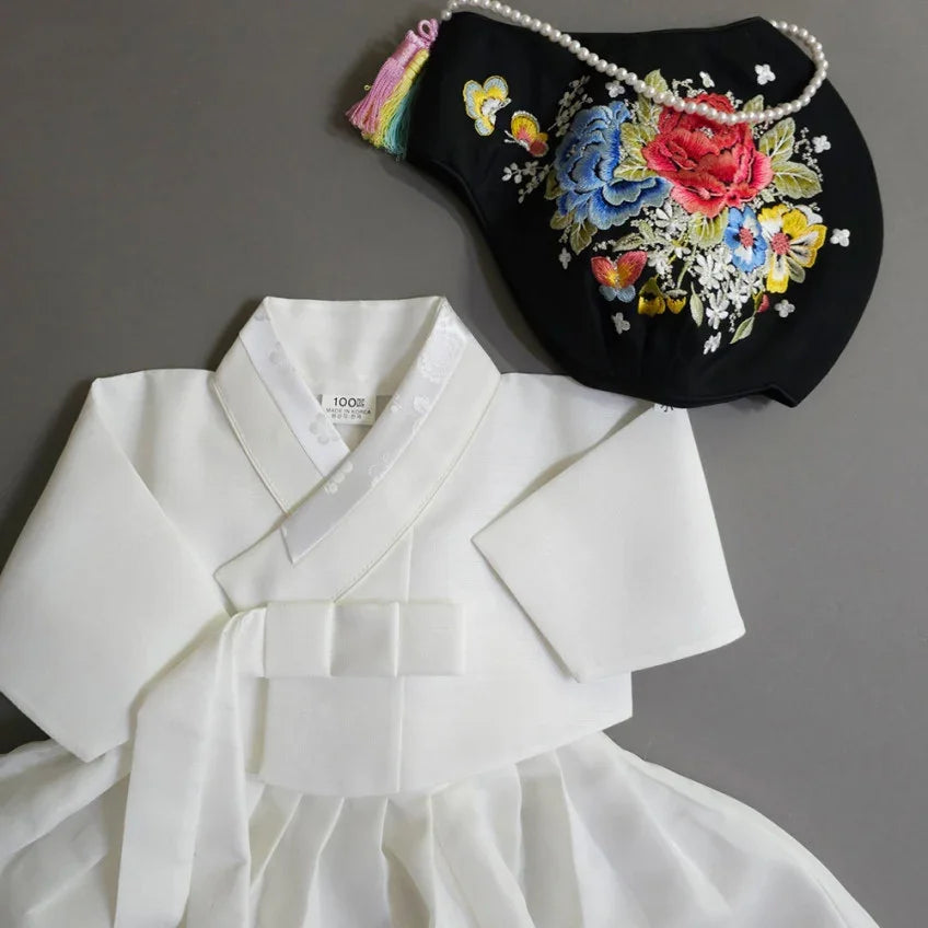 A white Native Korean hanbok paired with a black floral embroidered Jobawi.