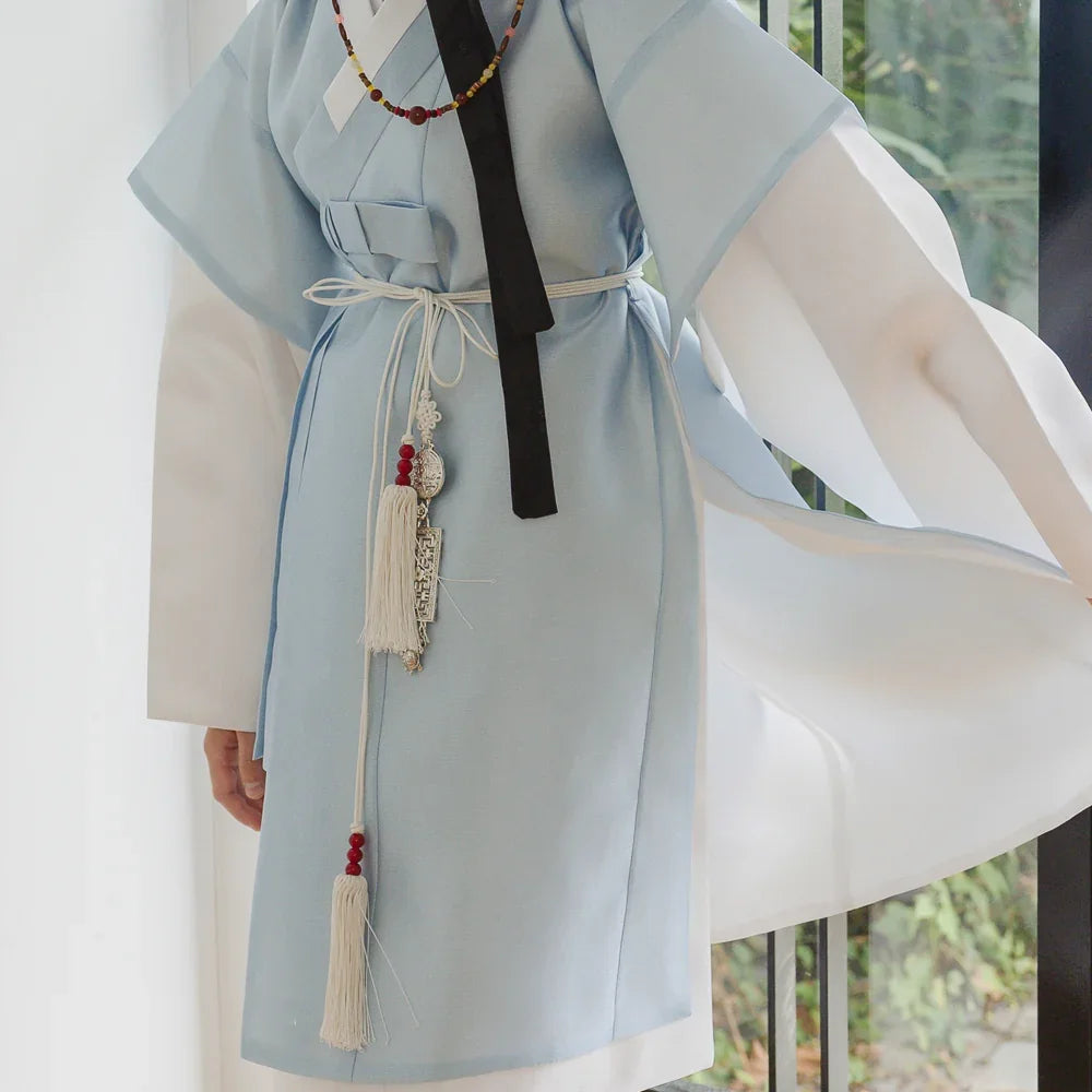 Close-up of a light blue Native Korean Boy Hanbok Dopo featuring a decorative Norigae tassel.