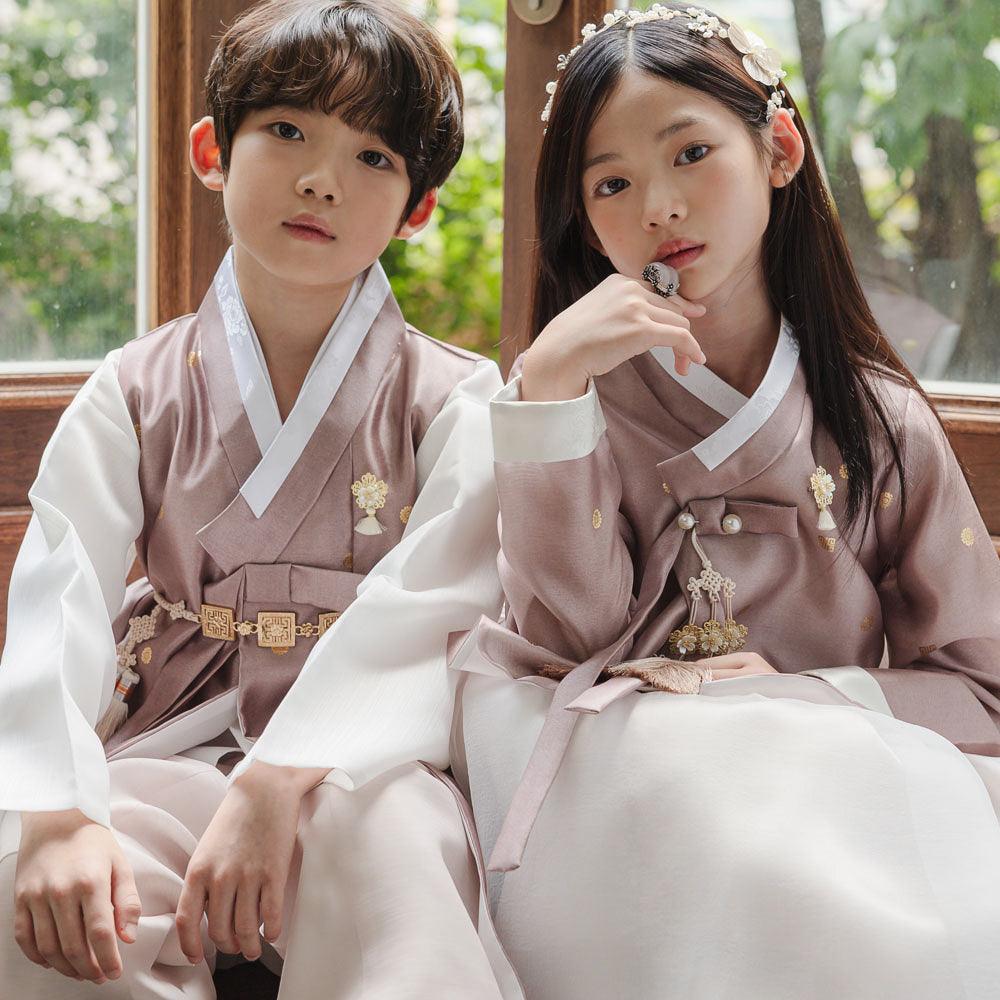 Children wearing brown Native Korean boy and girl hanbok with norigae accessories.