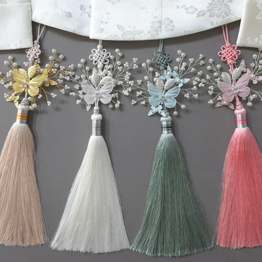 Four colorful Sana Butterfly Tassel Norigae from Native Korean in yellow, white, green, and pink.