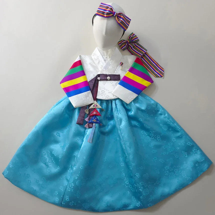Native Korean girl hanbok featuring a colorful saekdong jeogori and a sky blue skirt.