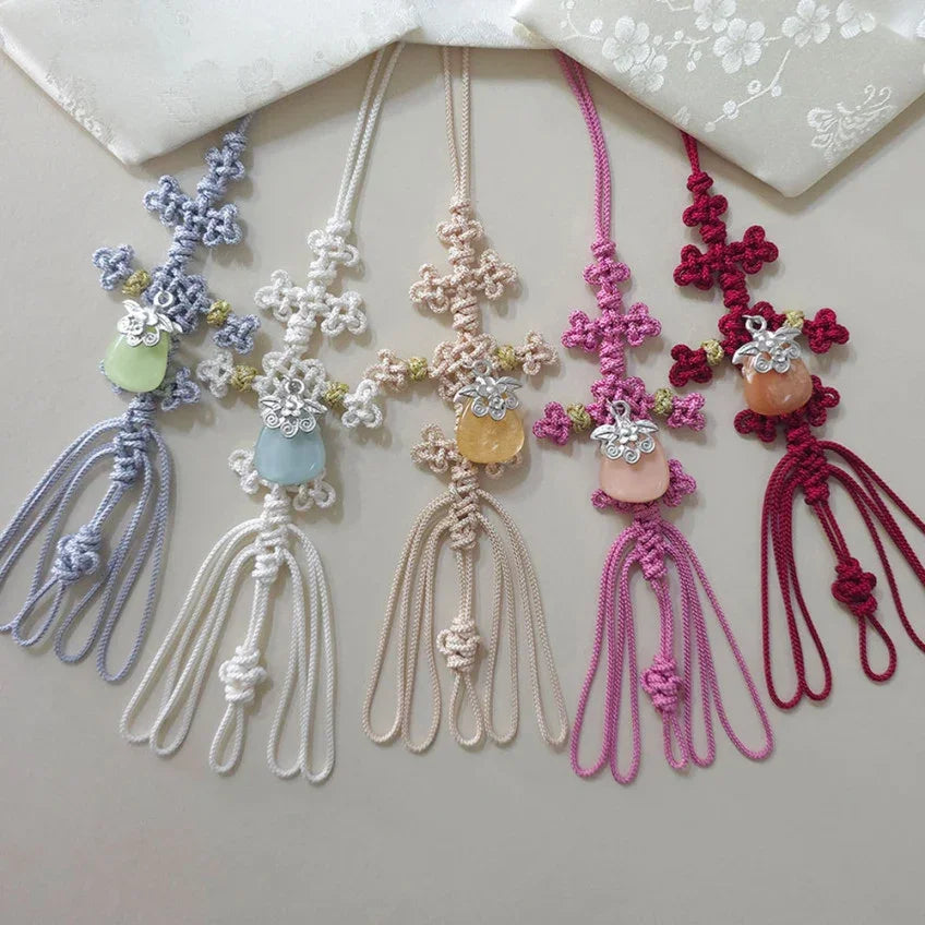 Five colorful Native Korean Norigae traditional charms with knotted cords and gemstones.