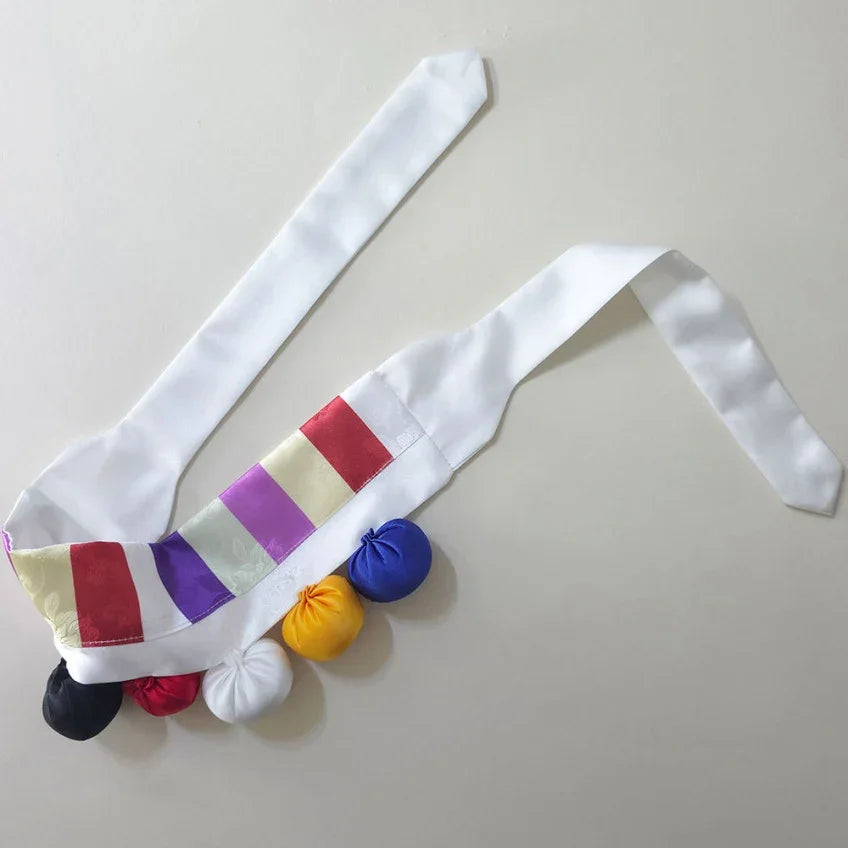 White Native Korean saekdong cushion belt with colorful striped accents and pom-poms
