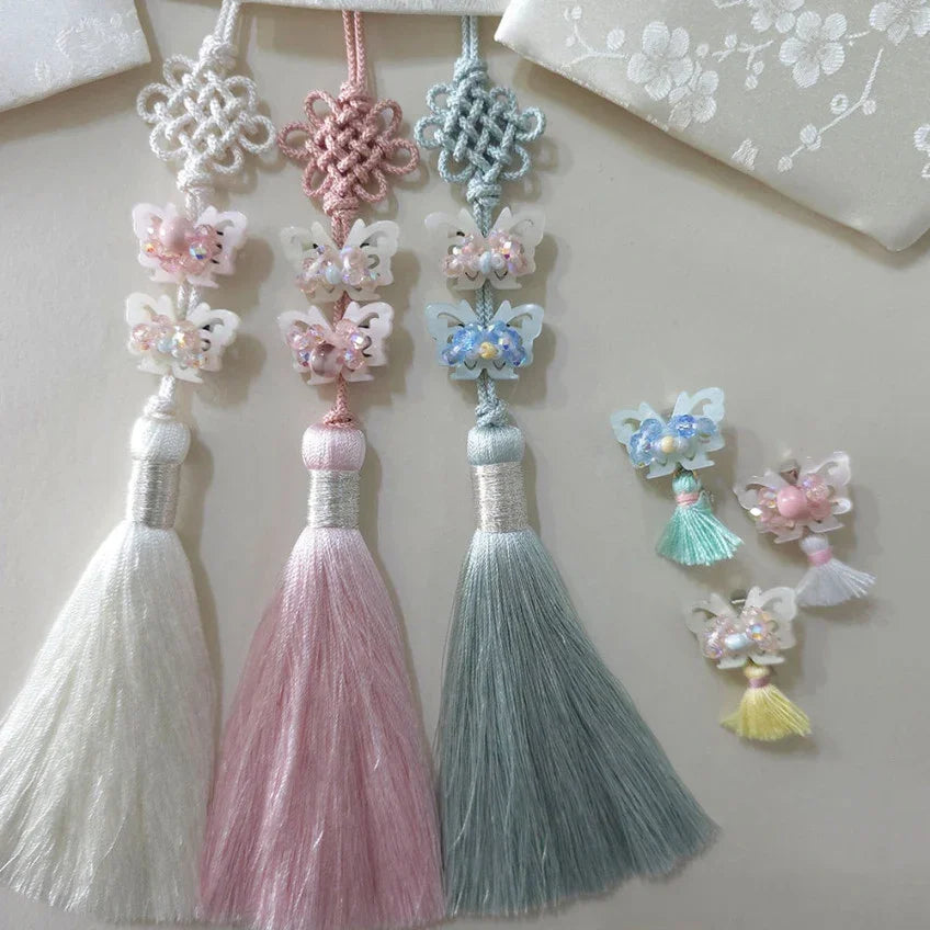 Three crystal butterfly Norigae by Native Korean in white, pink, and blue tones.