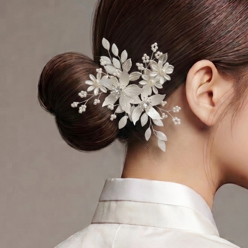 Korean Woman wearing a white floral Hanbok hairpiece with a neutral background