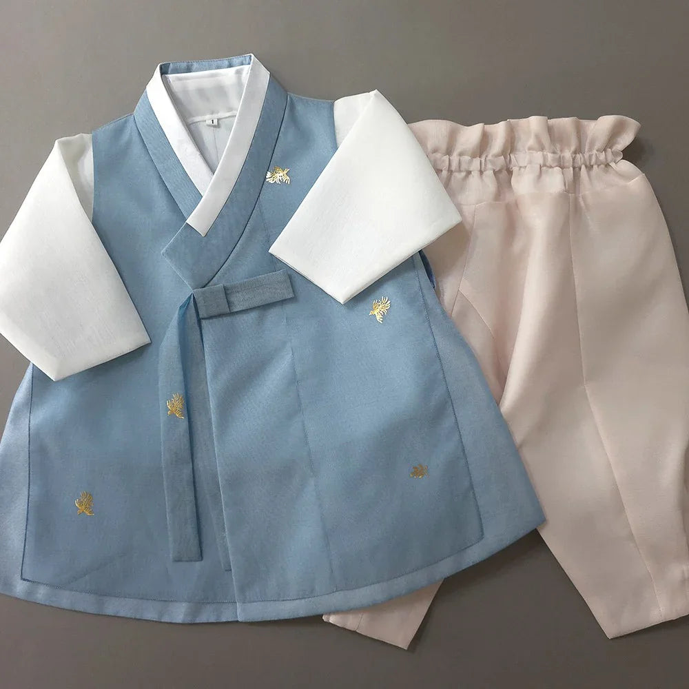 Heesung Sky Boy Hanbok by Native Korean featuring a light blue vest and pale pink pants.