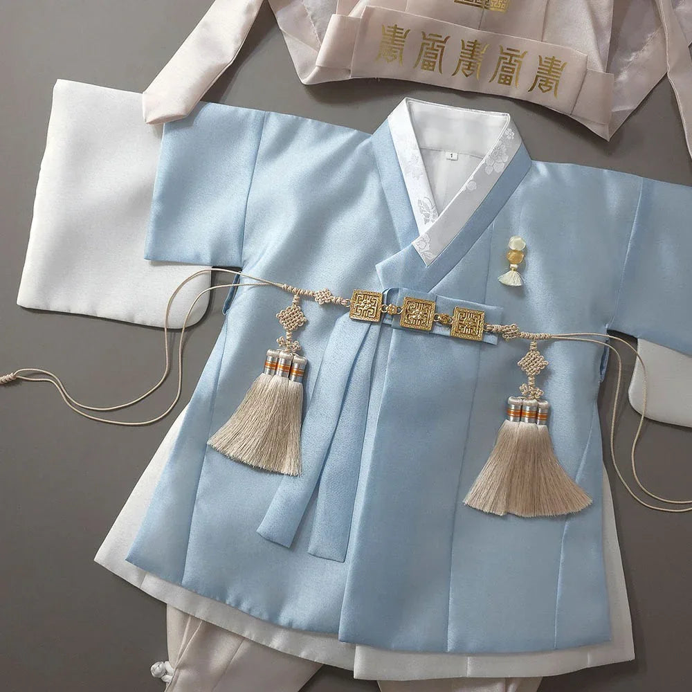 Light blue Native Korean Boy Hanbok Dopo with decorative Norigae tassels.