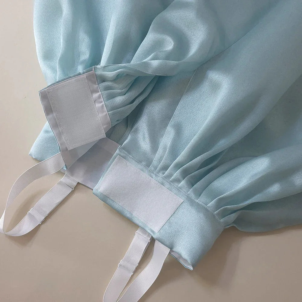 Close-up of the adjustable waist tie and light blue fabric of a Native Korean Girl Hanbok.