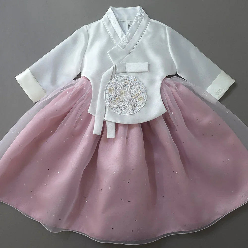 Pearl pink and white Native Korean girl hanbok with floral embroidery.