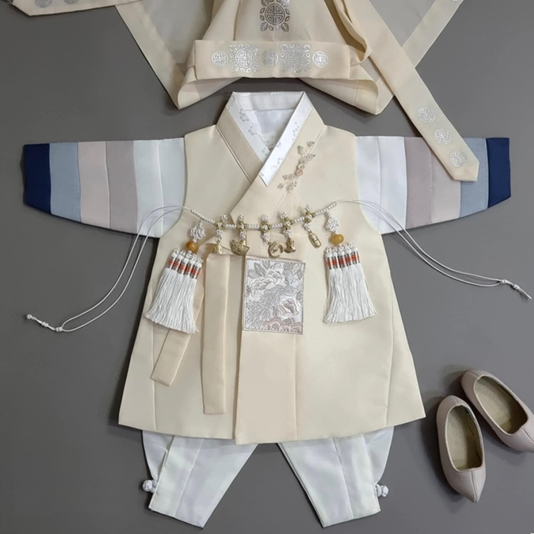 Traditional Korean boy hanbok set with yellow vest, striped jeogori sleeves, ivory pants, and beige norigae – perfect for Dol or Baek-il.