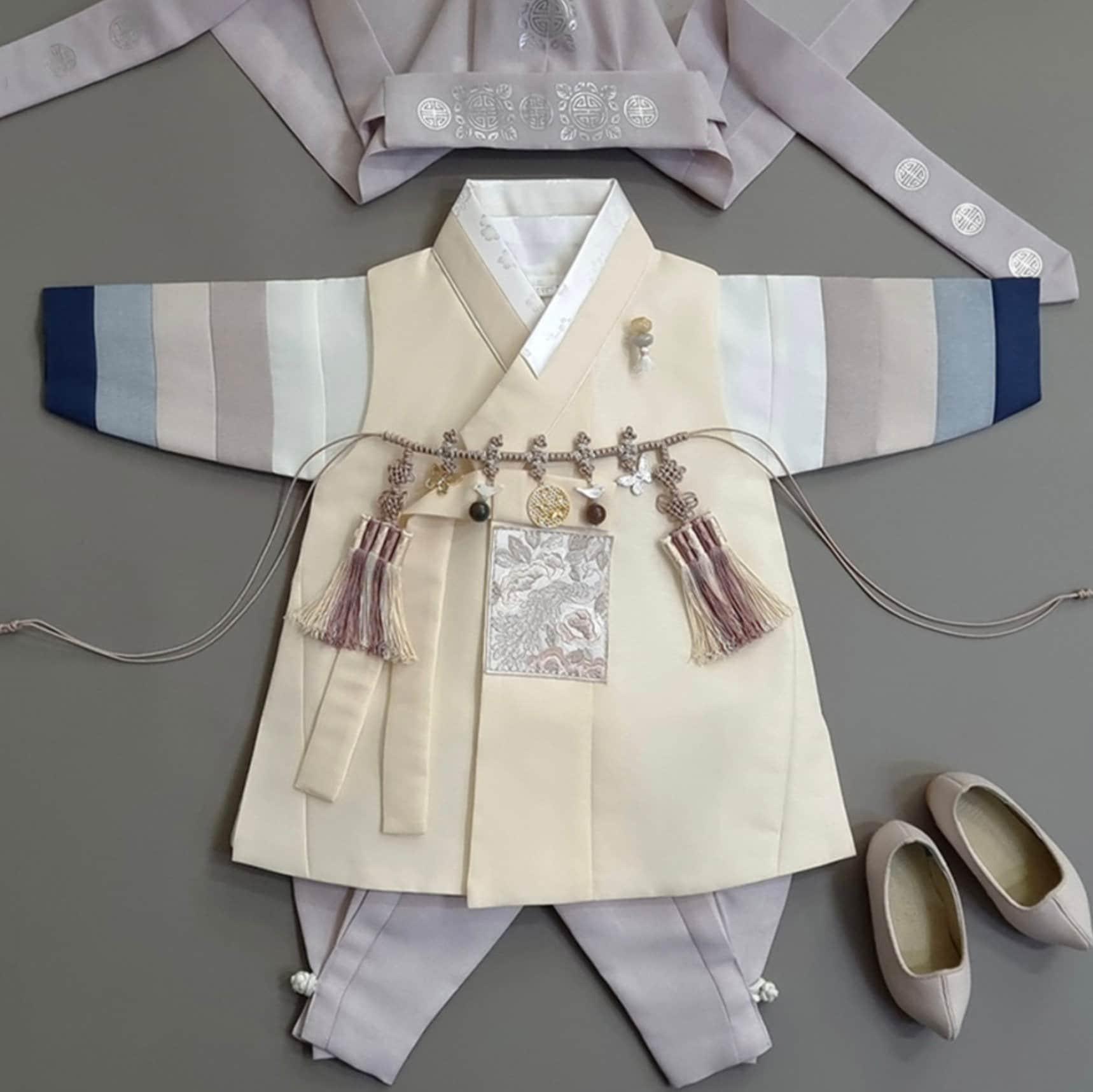 Jeongwoo Yellow Stripe Hanbok styled with pink-gray pants – elegant Korean outfit for boys’ first birthday celebration.