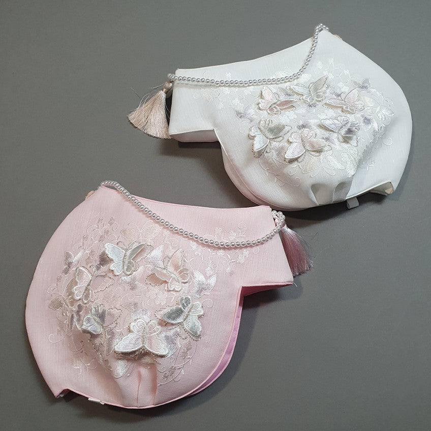 Butterfly Embroidered Jobawi traditional Korean girl hanbok hat featuring 3D butterfly embroidery, pearl trim, and a decorative tassel in ivory and pink for Dol, Baek-il, and Korean celebrations.