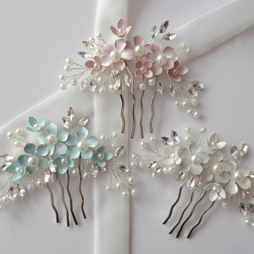 Set of floral hair combs with pearls and crystals on a white background
