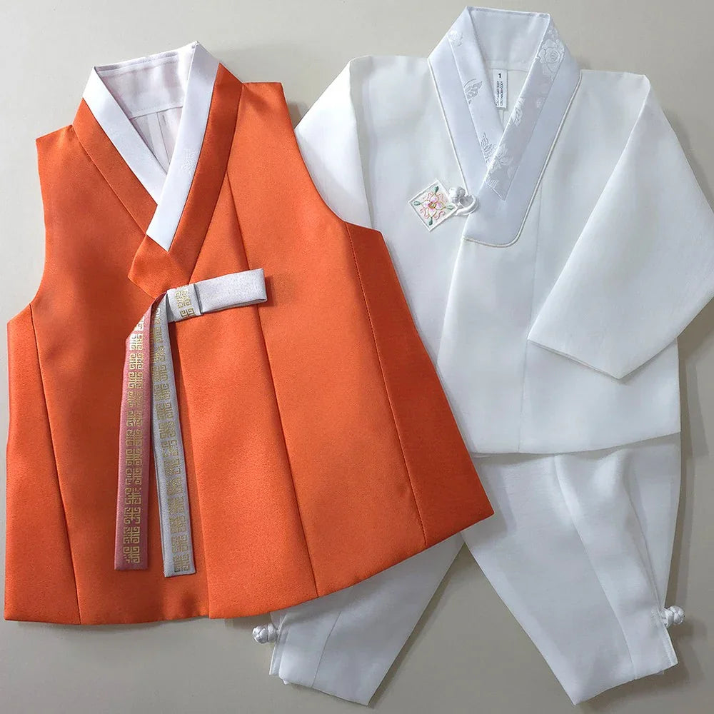 Eunkyo Coral Vest Boy Hanbok by Native Korean with a white jacket and matching pants.