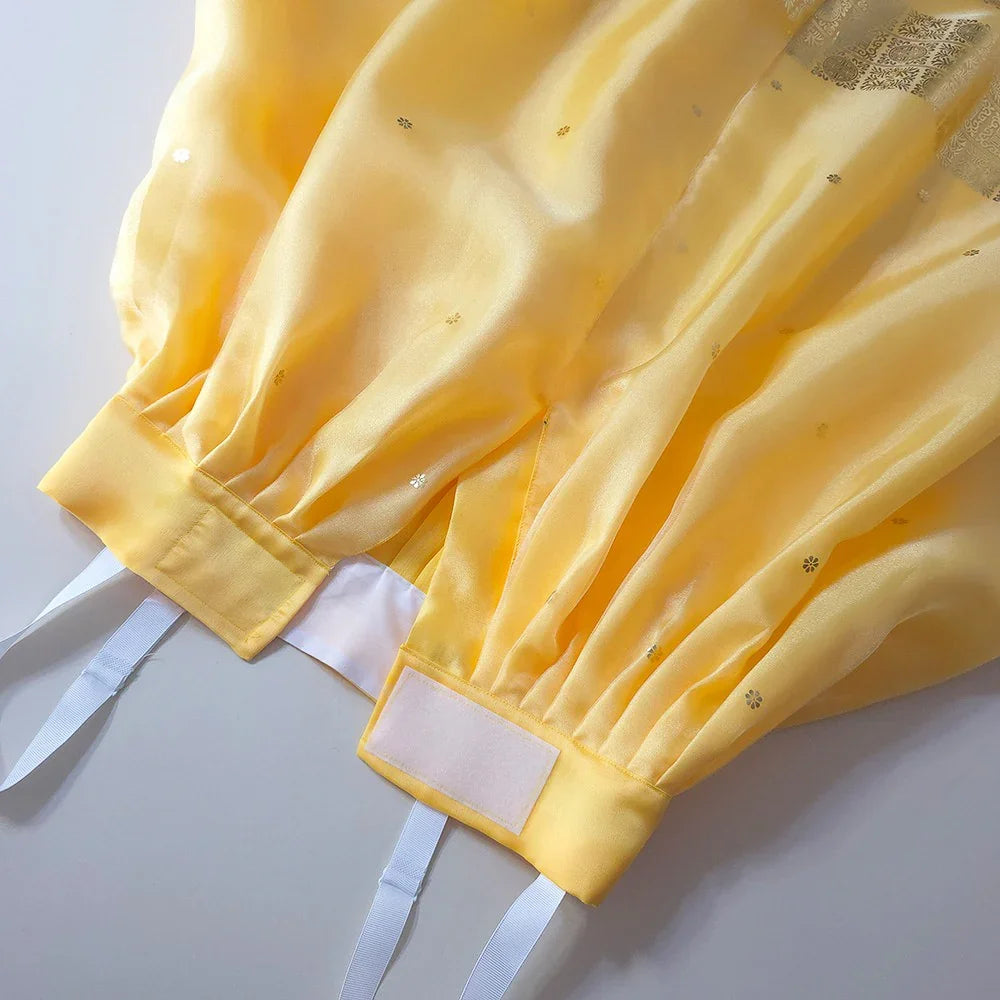 Close-up of the yellow fabric and waistband of a Myoung Magenta Girl Hanbok.