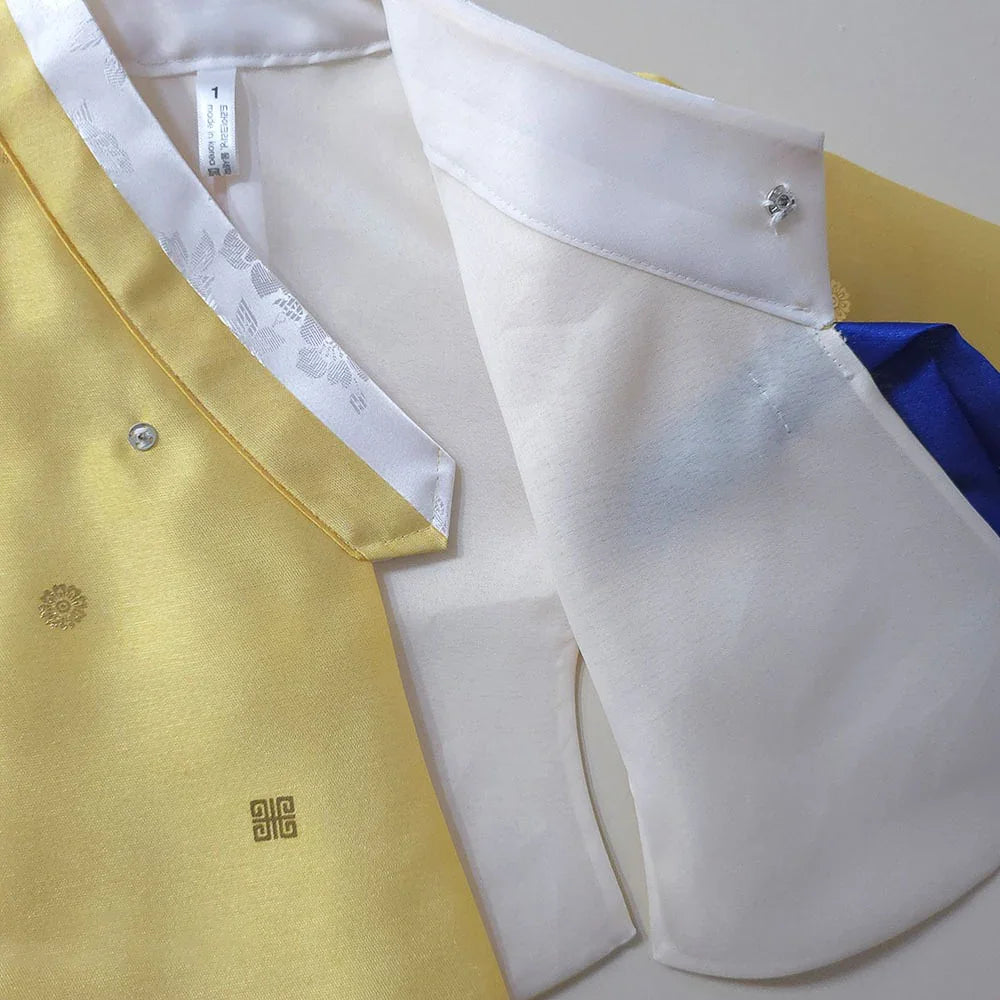 Close-up detail of a yellow and white Native Korean girl hanbok with traditional embroidery.